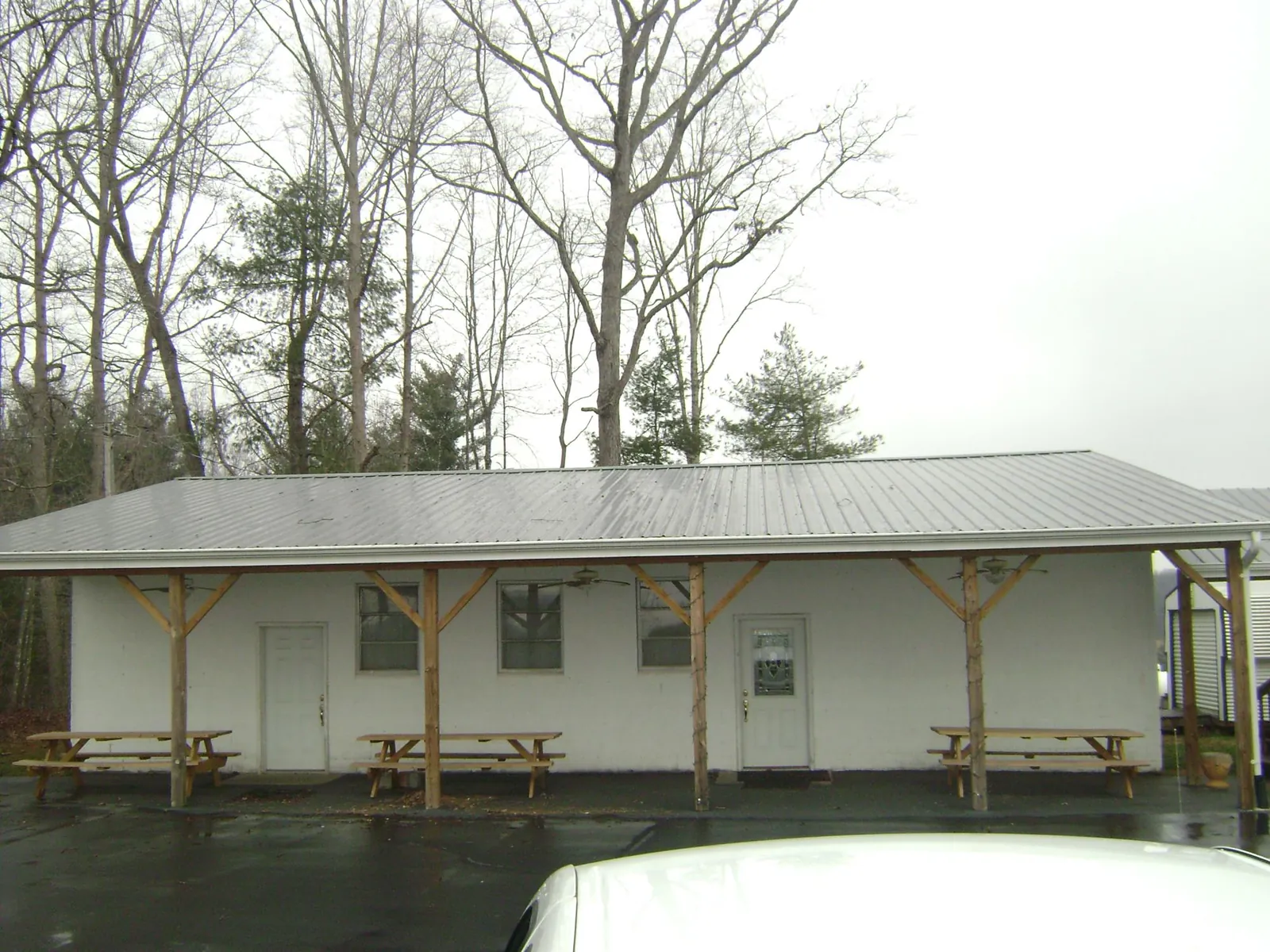 Gray metal roof over a block building with a timber post porch in Pleasantville